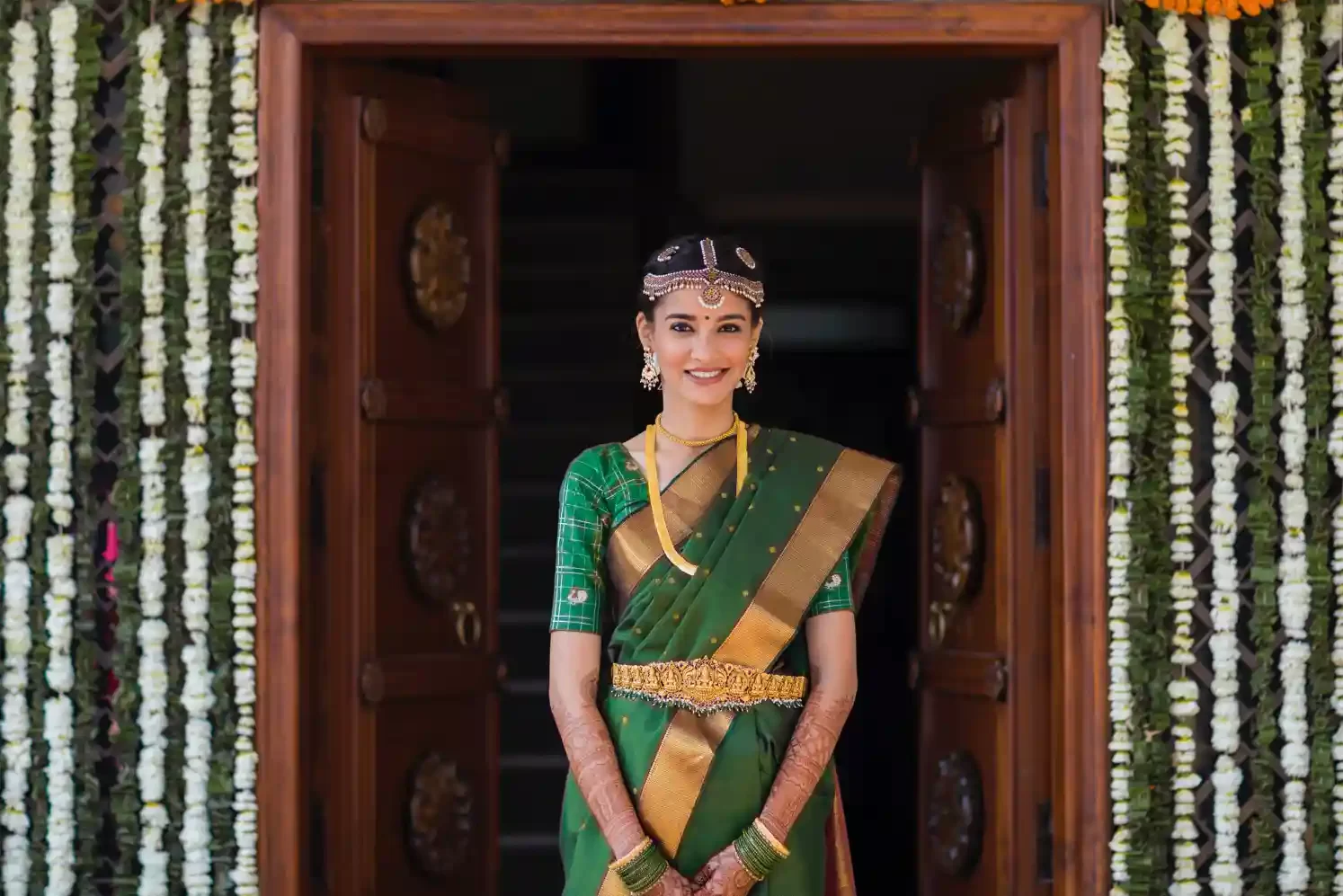 The bride poses gracefully in her stunning wedding outfit against the backdrop of Neemrana Fort, capturing a moment of pure elegance.