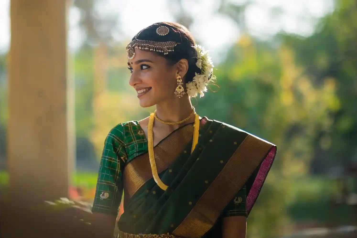 The bride poses gracefully in her stunning wedding outfit against the backdrop of Neemrana Fort, capturing a moment of pure elegance.