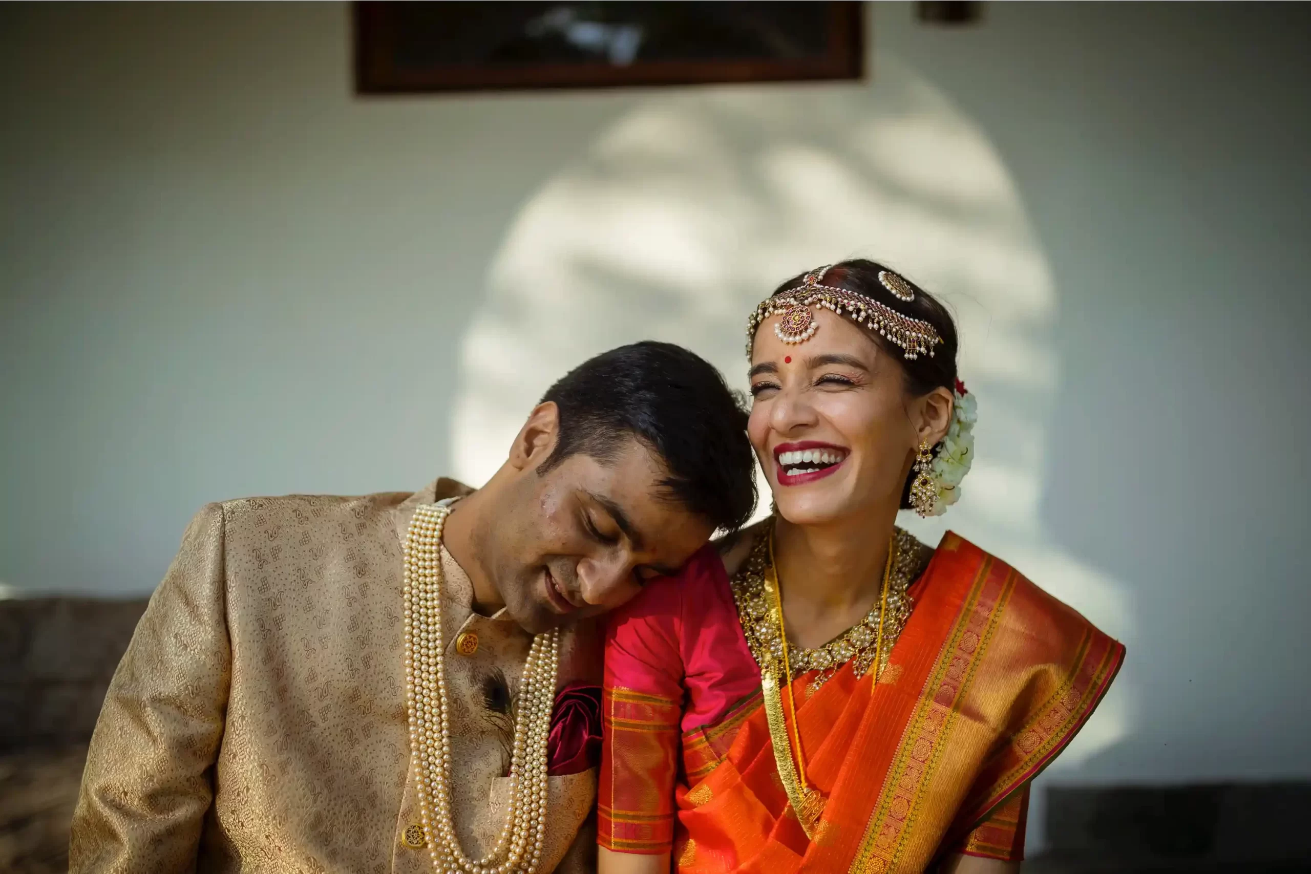 Intimate moment between the couple at Neemrana Fort, framed by the beautiful backdrop of ancient walls and lush greenery.