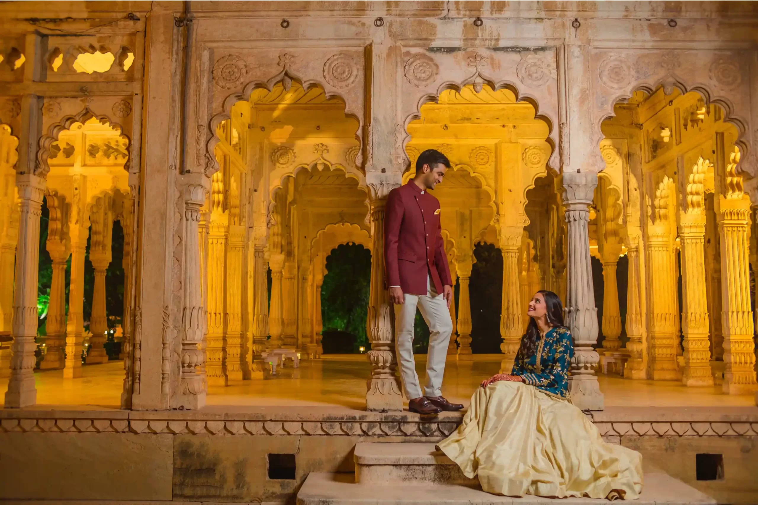 Romantic couple portrait at Neemrana, showcasing the love and joy of their destination wedding amidst stunning heritage architecture.