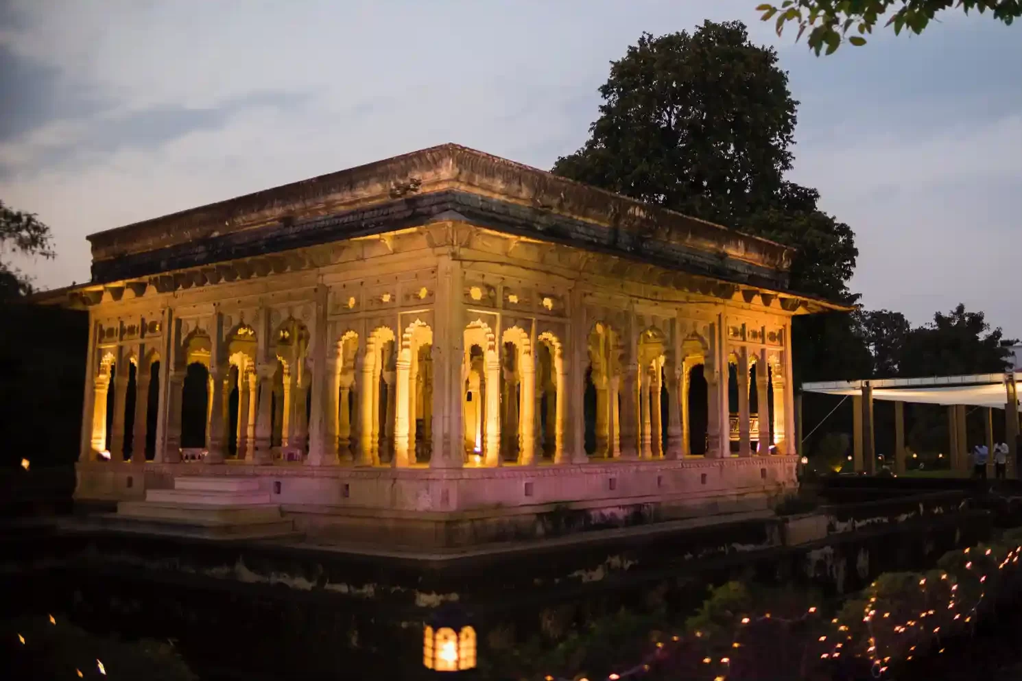 Wide-angle shot showcasing the breathtaking architecture of Neemrana Fort as a backdrop for a destination wedding celebration.