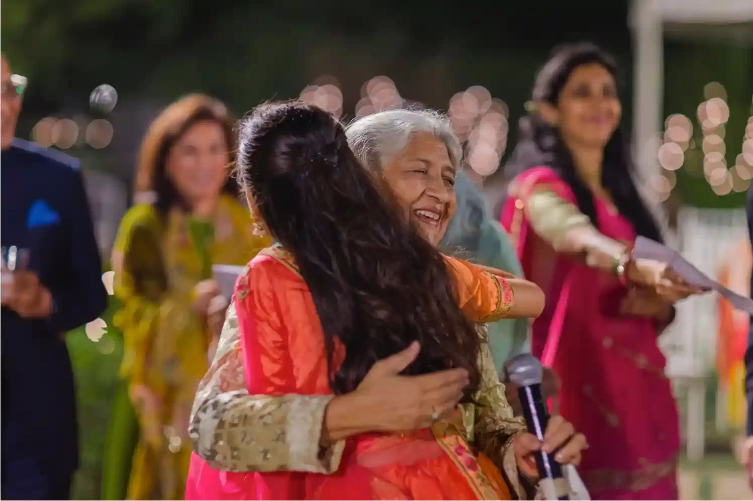 view of wedding guests celebrating at Neemrana, surrounded by historic architecture and lush gardens.
