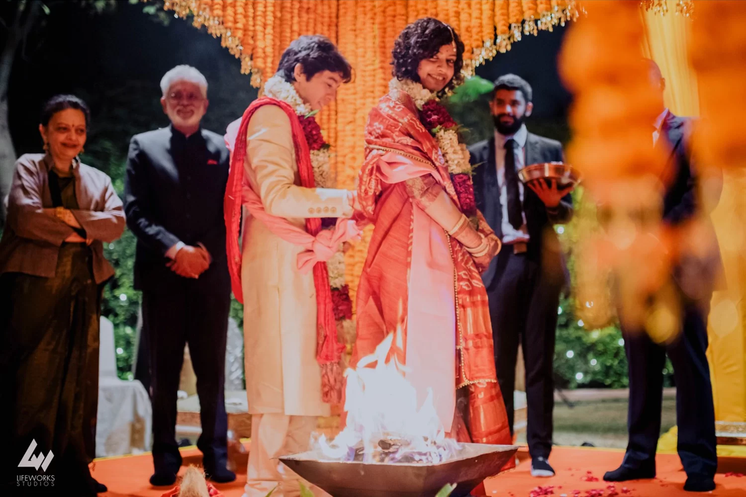 The couple takes pheras during their Hindu wedding in Dubai, walking around the sacred fire, signifying their eternal bond and commitment.