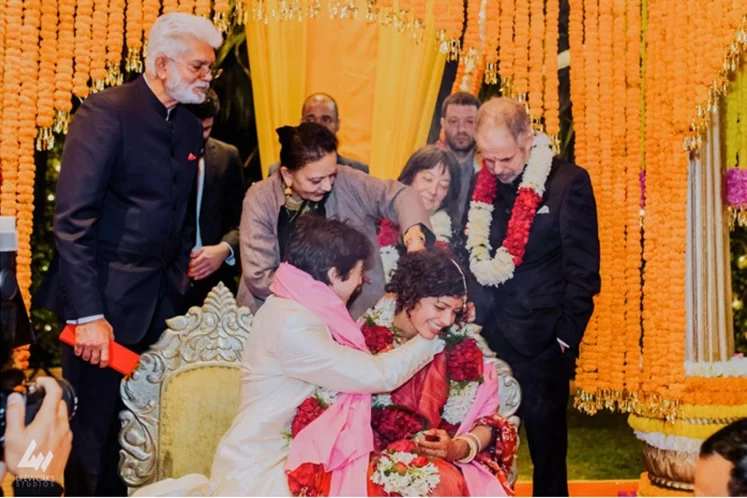 During their Hindu wedding in Dubai, the groom lovingly ties the mangalsutra around the bride's neck, symbolising their marital union.
