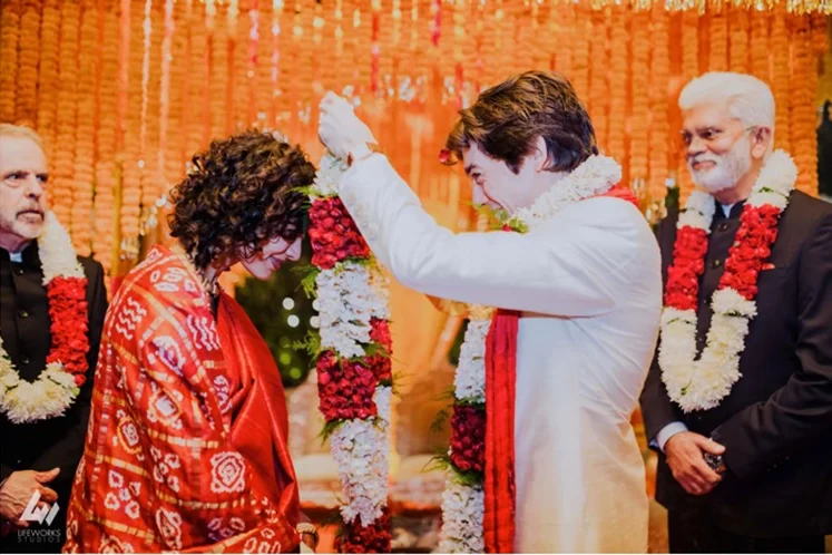 The Hindu wedding in Dubai features the varmala ceremony, where the bride and groom exchange floral garlands amidst joyous celebrations.