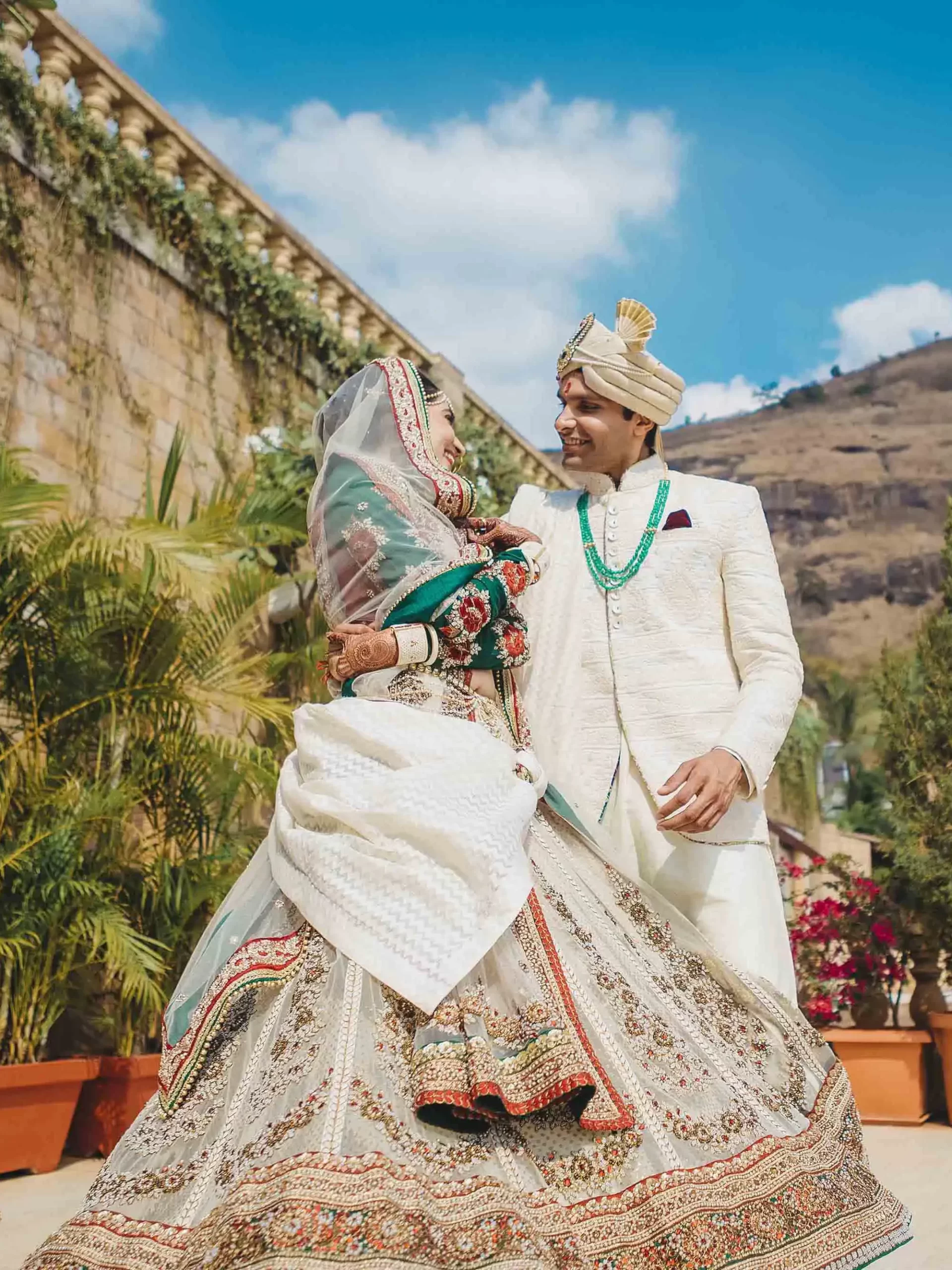 A couple poses joyfully after their wedding in Rajasthan, dressed in traditional attire, beautifully captured by the best wedding photographer in India.